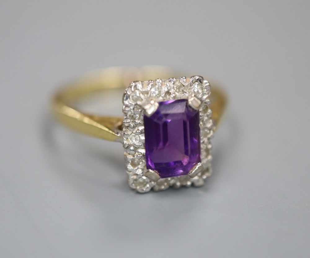 An 18ct, amethyst and diamond chip set rectangular cluster ring, size M, gross 3.3 grams.